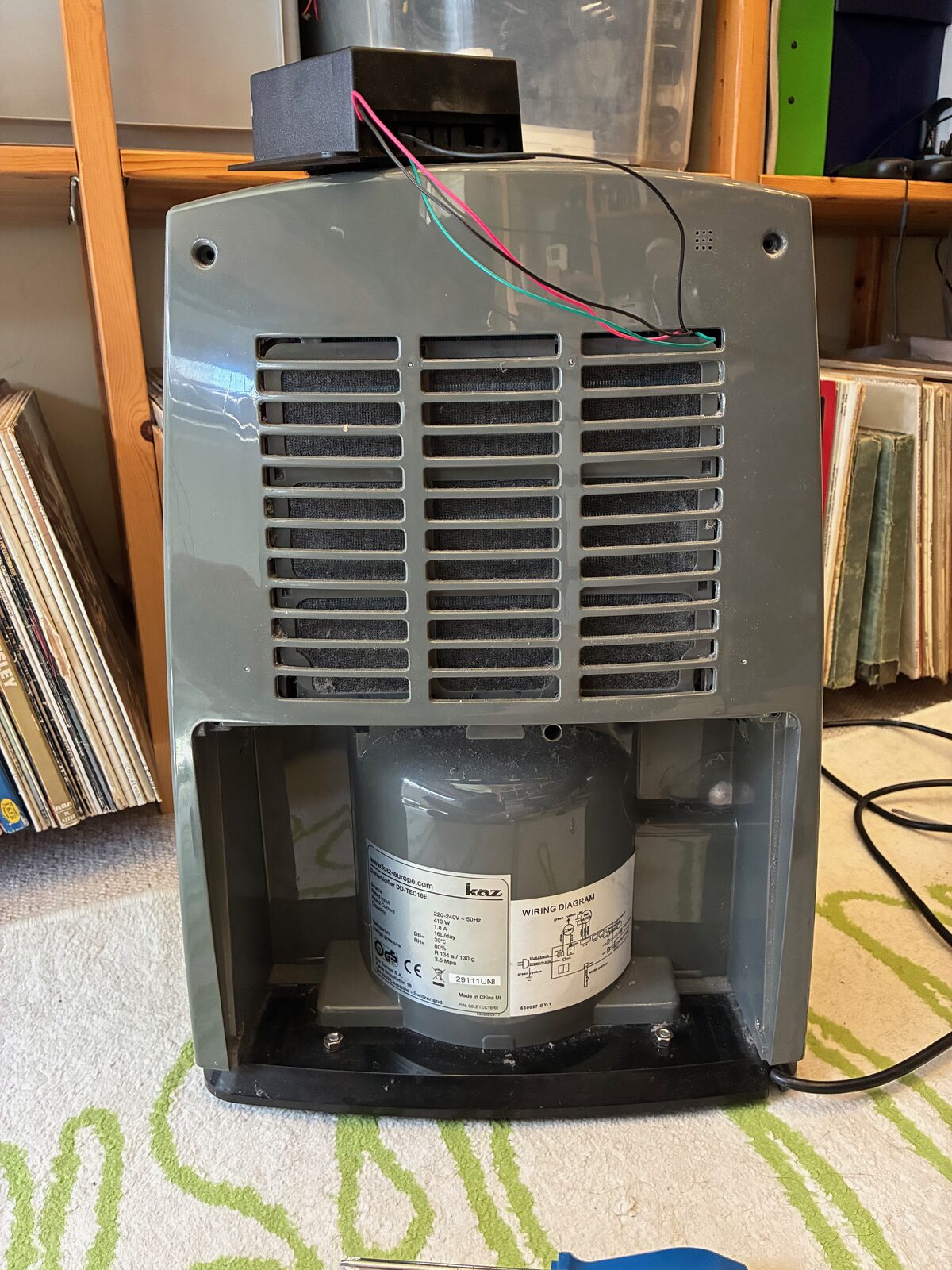 Kaz DD-TEC16E dehumidifier with the back panel removed, showing fan and compressor